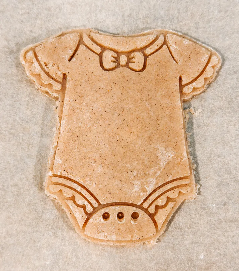 Baby shower cookie cutters including onesie, bottle, and stroller designs