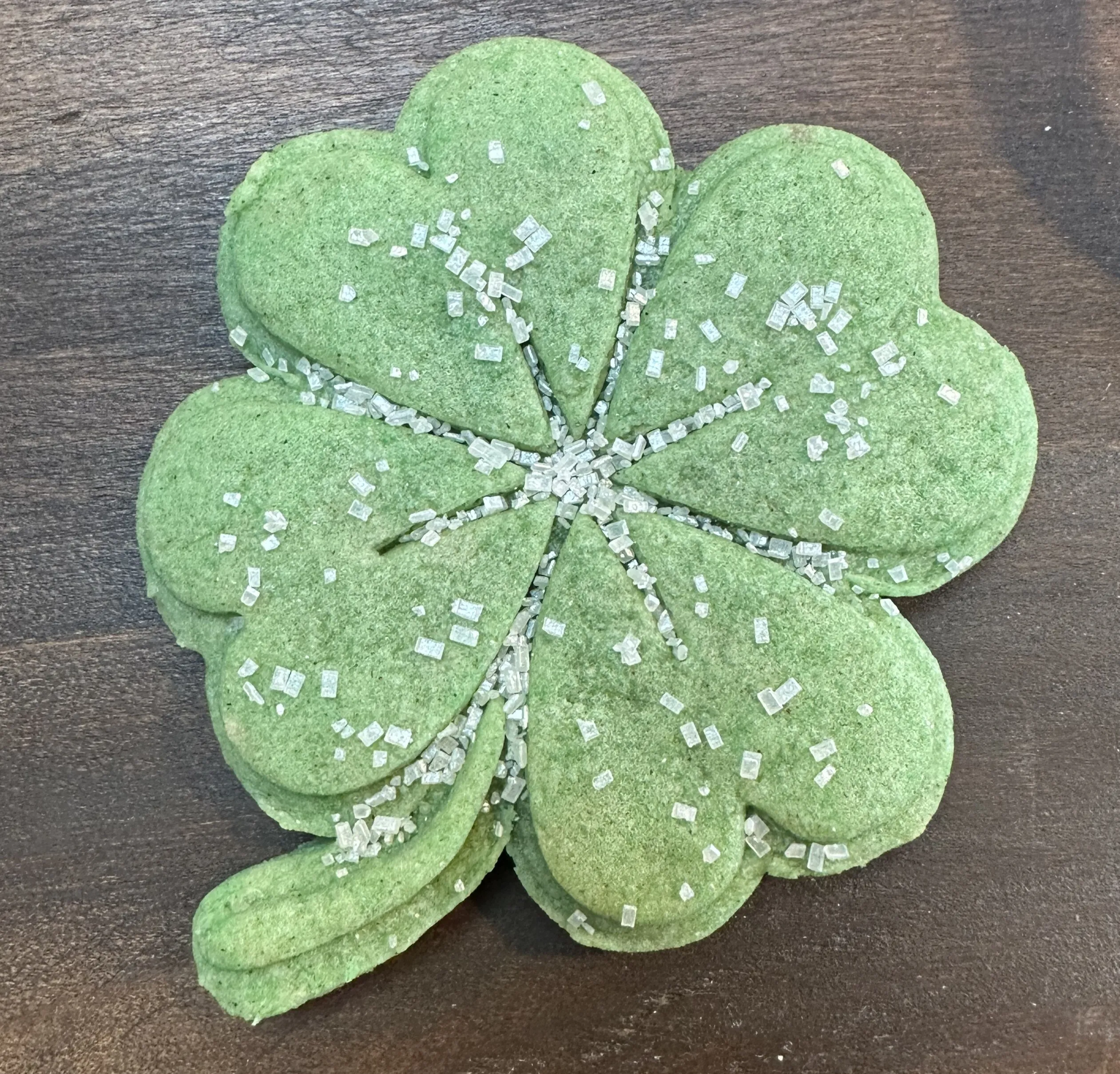 Green stamped shamrock cookie with sprinkles